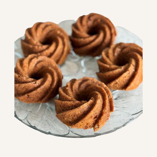 5 banana bread mini bundt cakes ready for an event on glass platter