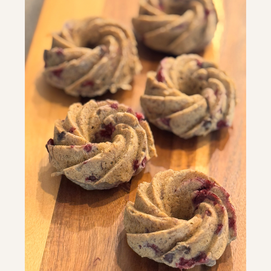 Oatmeal banana raspberry chocolate chip mini bundt cakes ready for an event on wooden board