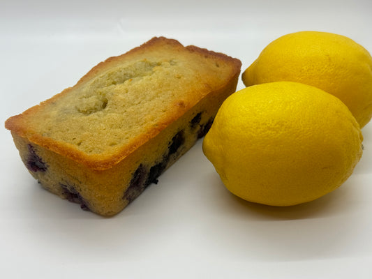 Picture of lemon blueberry sweet bread loaf with two lemons