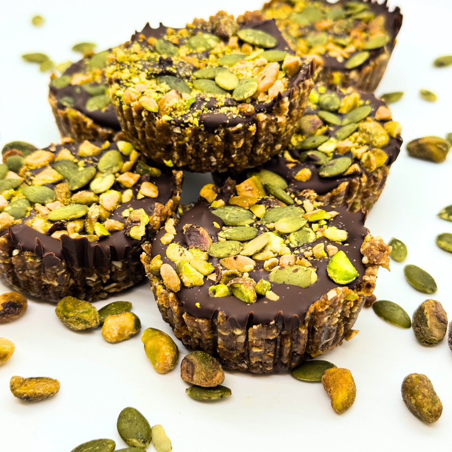 Photo of organic peanut-free and raw vegan dessert cups with pistachios, pumpkin seeds, and chocolate– soy-free, corn-free gluten-free dessert handmade in Fort Myers, Florida.