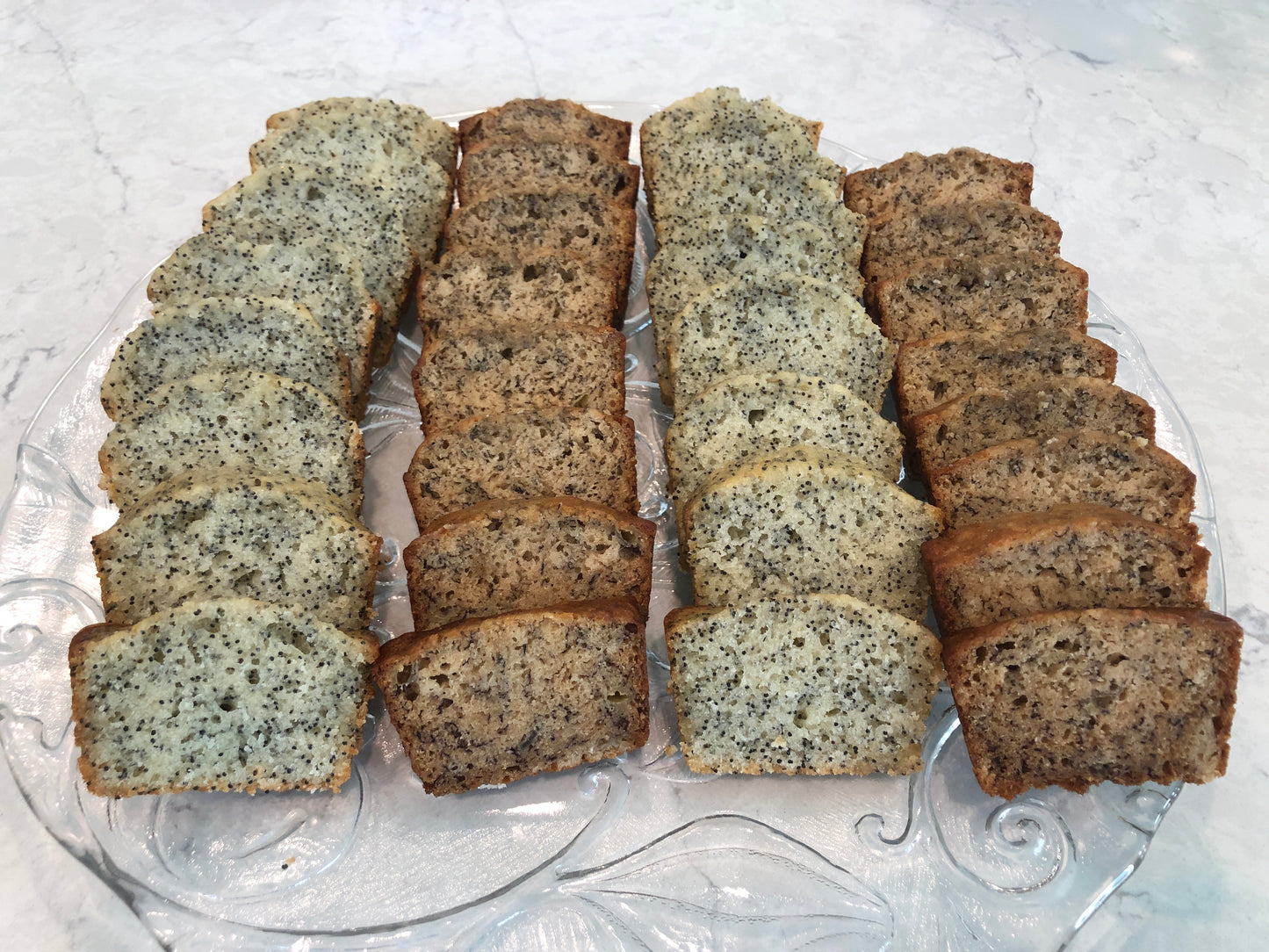 A platter with four loaves of sliced sweet bread on a platter