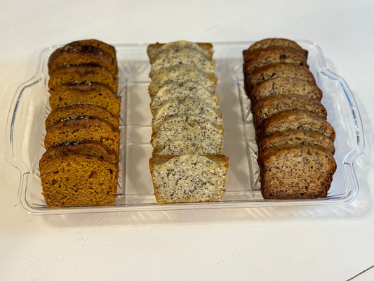 A photo of three loaves of sliced sweet bread: pumpkin, almond poppyseed and banana