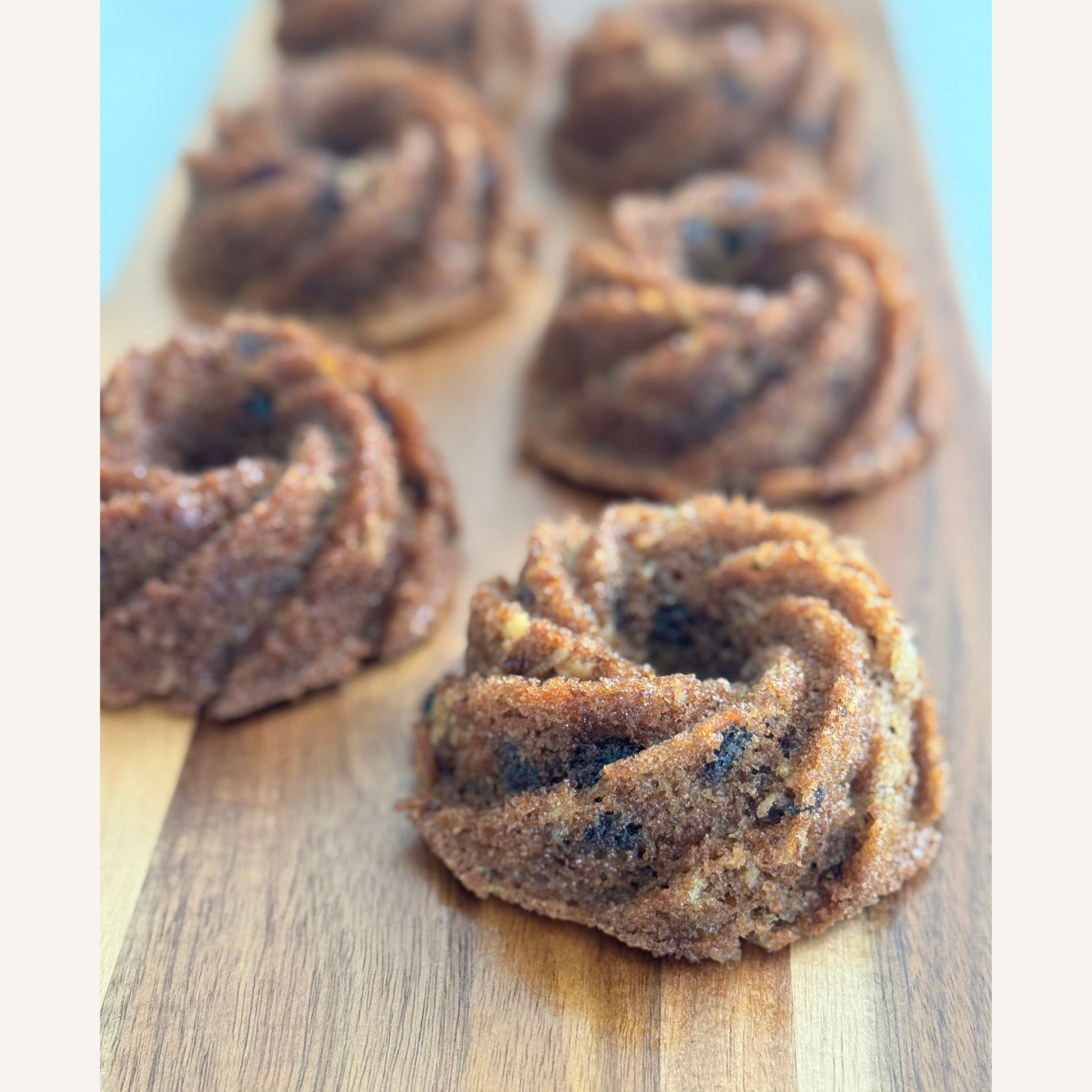 Carrot cake mini bundt cakes ready for an event on wooden board