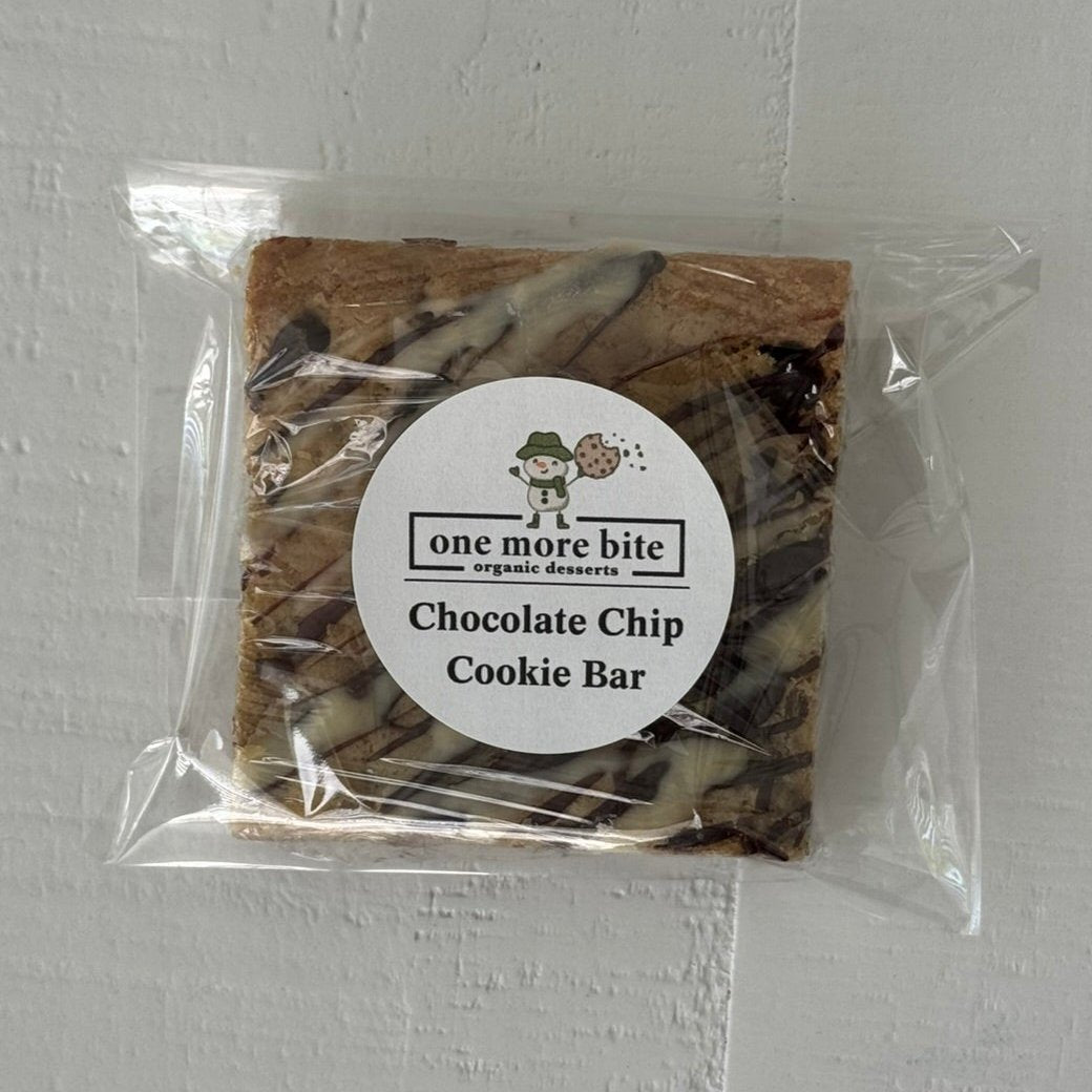 Packaged chocolate chip cookie bar with One More Bite Organic Desserts  branding on a white background. Organic peanut-free chocolate chip cookie bar party pack – soy-free, corn-free dessert handmade in Fort Myers, Florida.