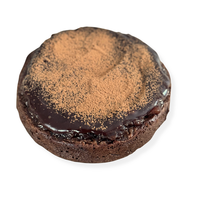 Photo of organic peanut-free chocolate flourless cake with ganache and dusted cooca powder and organic raspberry jam – soy-free, corn-free gluten-free dessert handmade in Fort Myers, Florida.